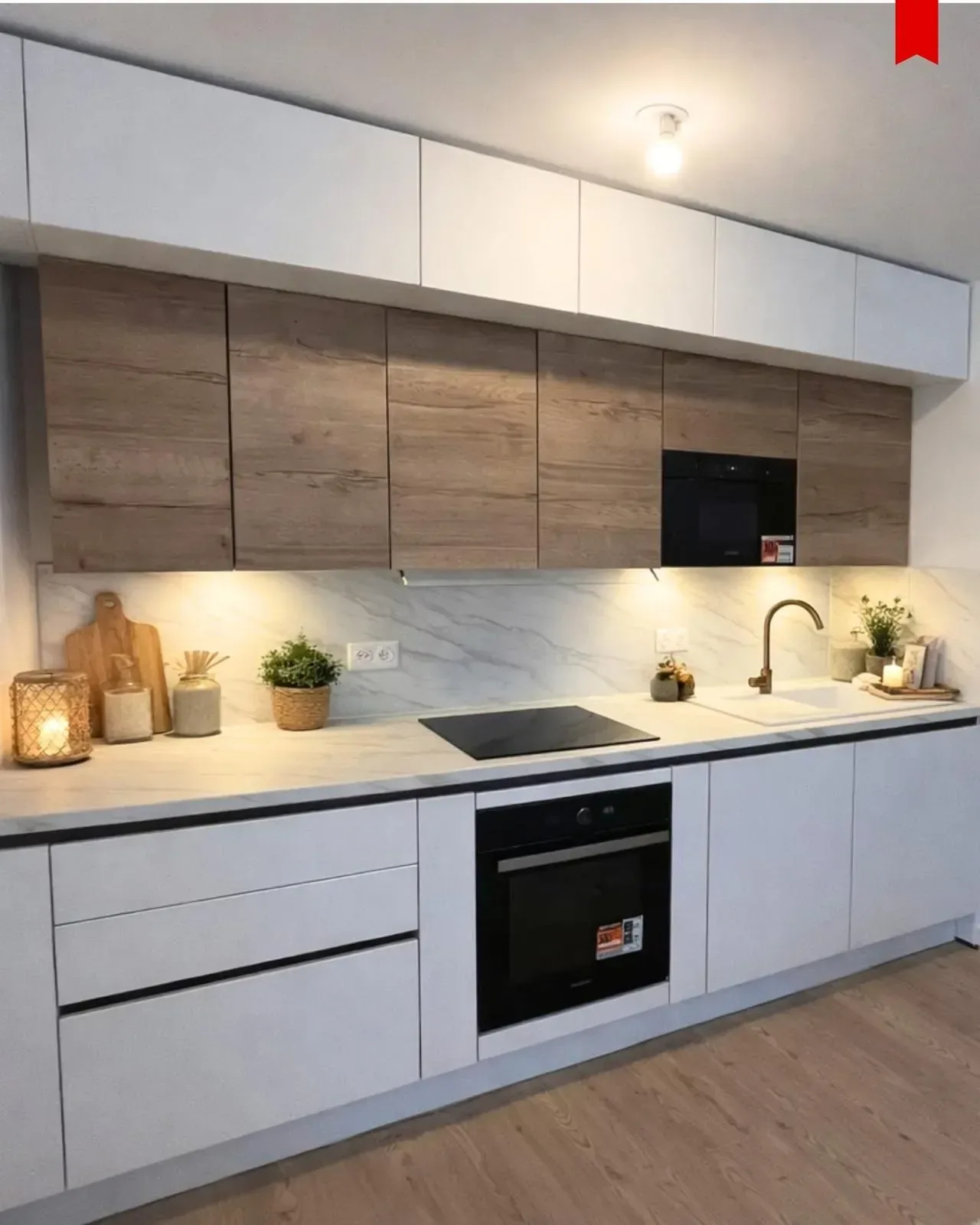 Cuisine linéaire design blanche et bois avec crédence en marbre et mitigeur doré