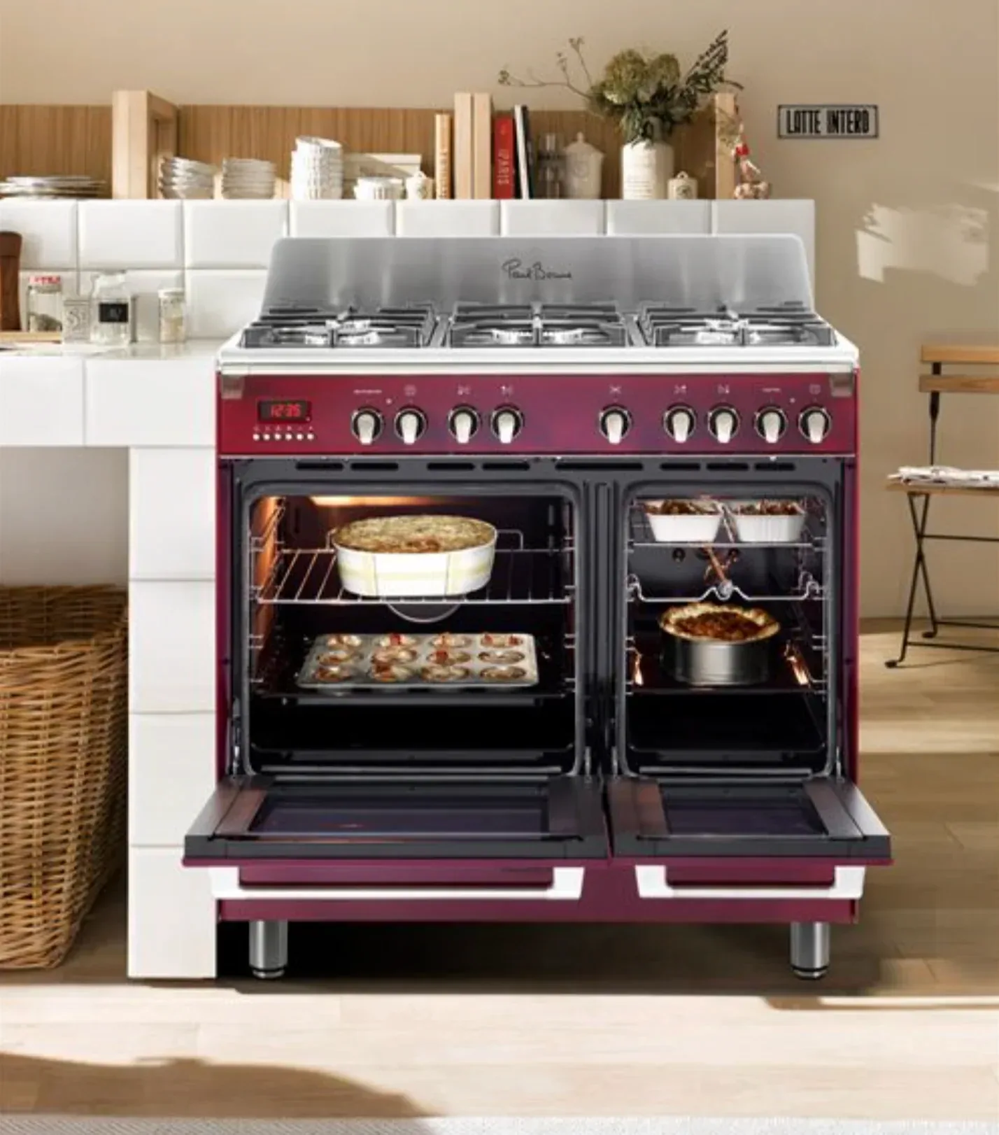 Piano de cuisson Rosières bordeaux avec double four ouvert et plats en cuisson
